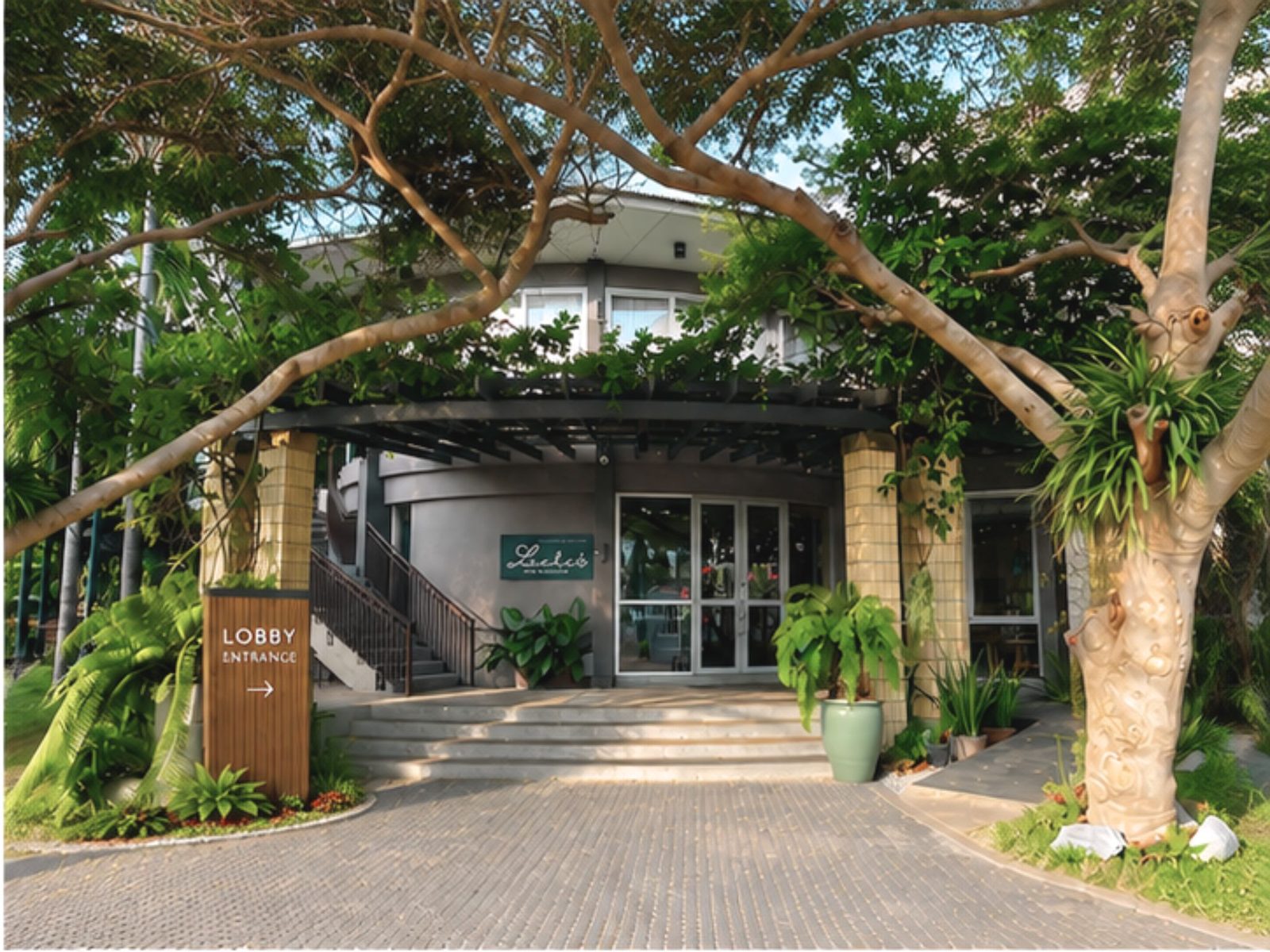 The Leela Resort & Spa Pattaya lobby entrance under the trees
