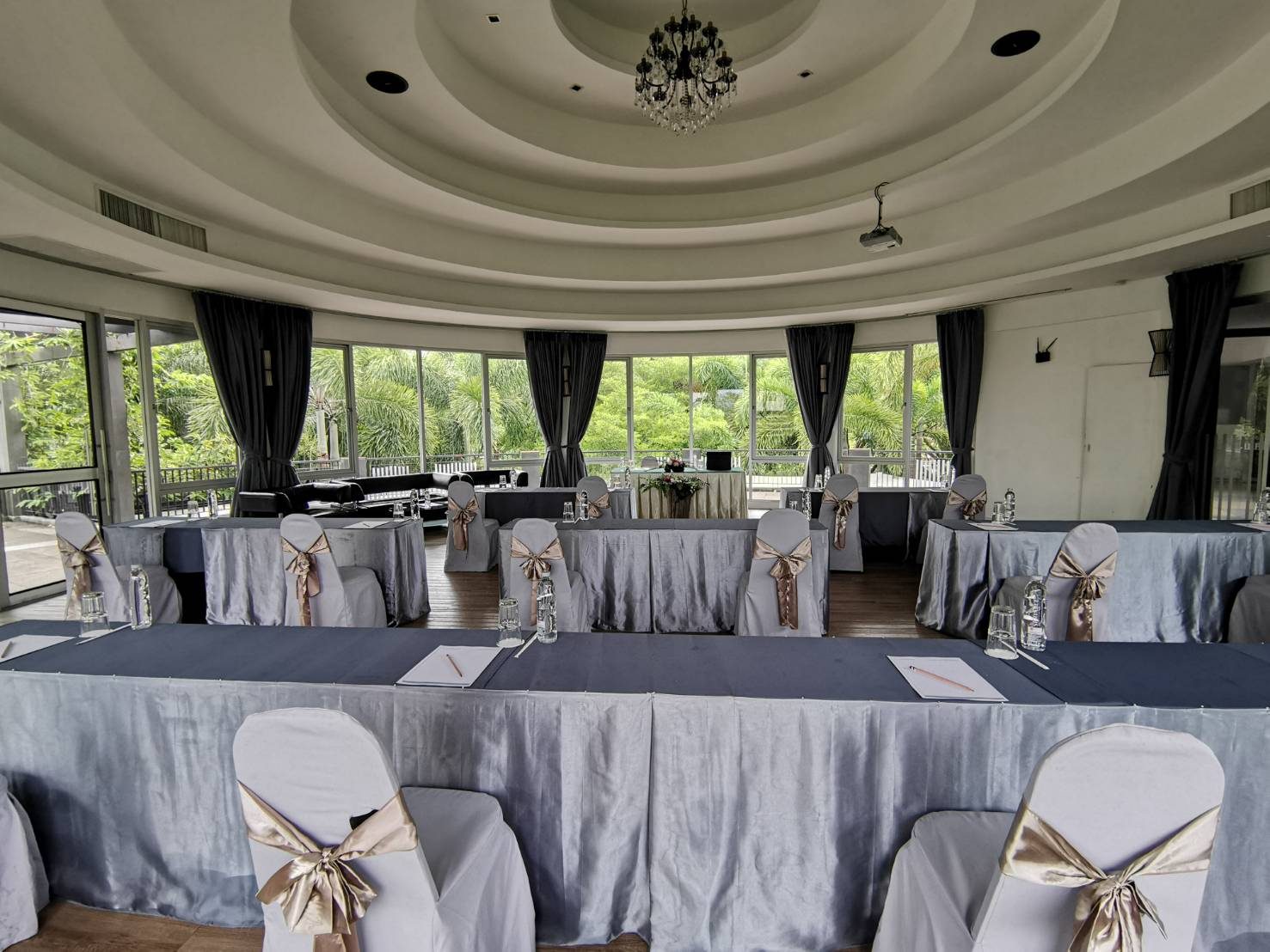Leela Sala set up boardroom-style with a center microphone at The Leela Resort & Spa Pattaya