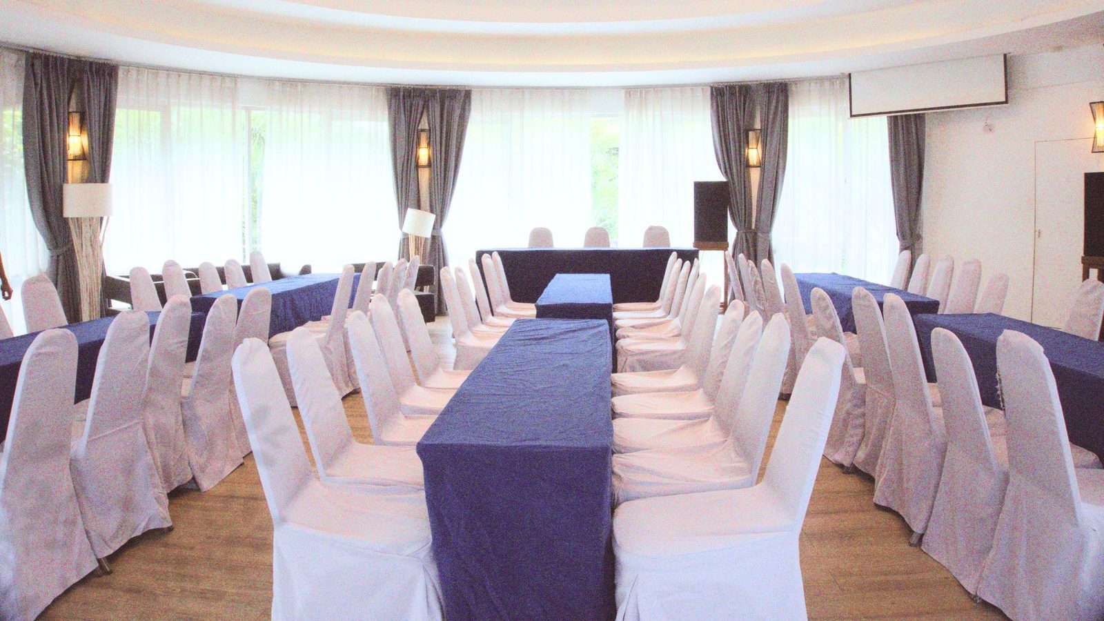 Leela Sala theatre-style setup with projector screen at The Leela Resort & Spa Pattaya