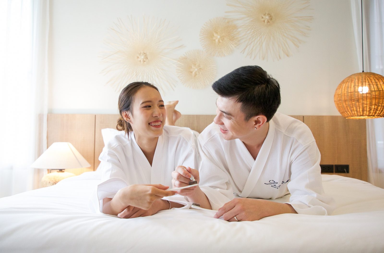 Couple relaxing in bathrobes on the bed