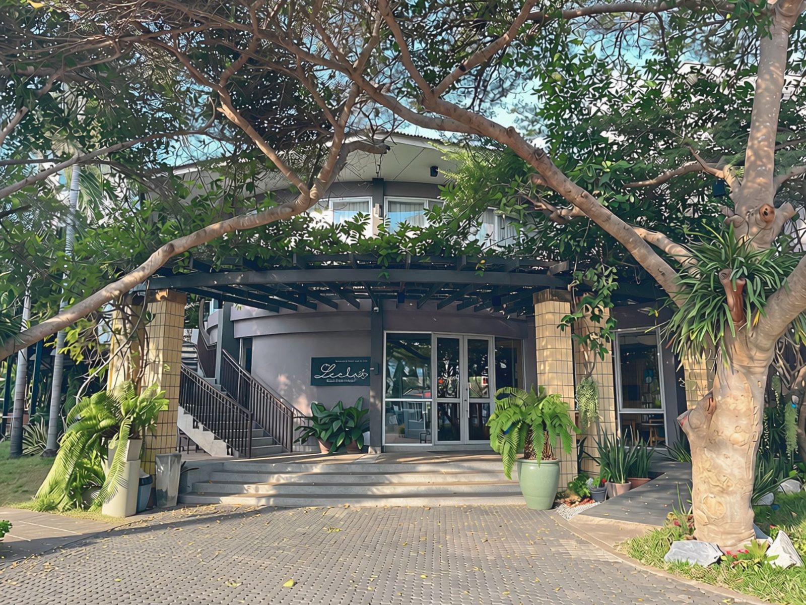 The Leela's entrance under the trees