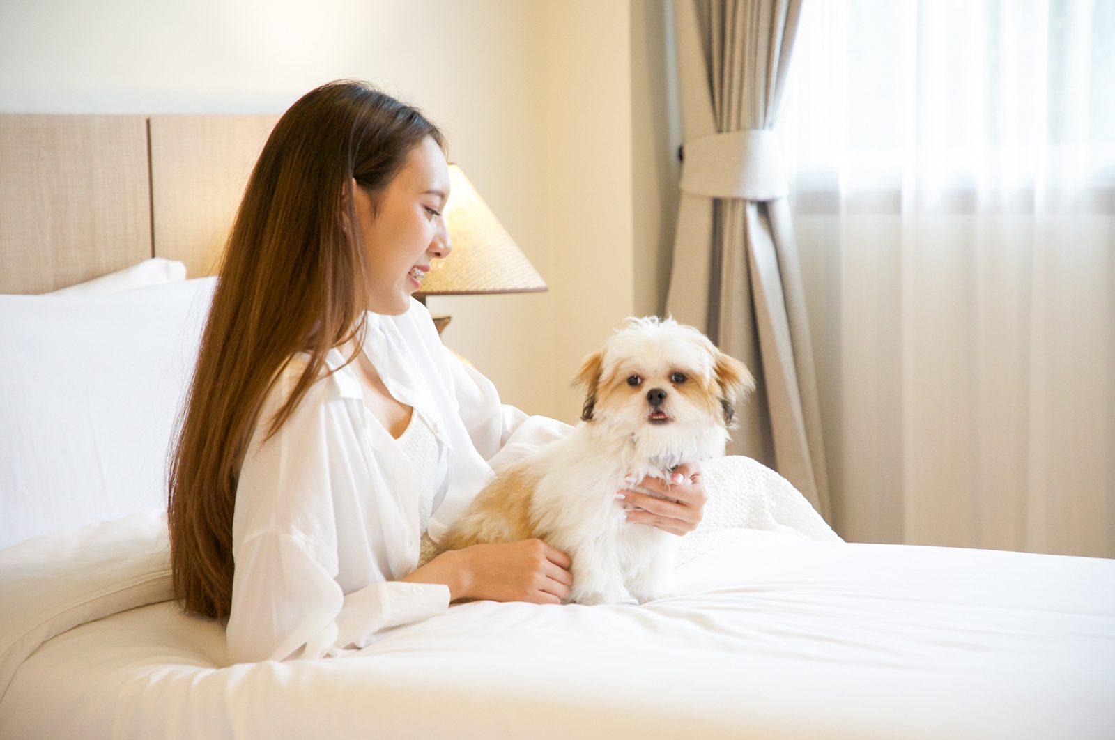 Guest and her dog relaxing on the bed