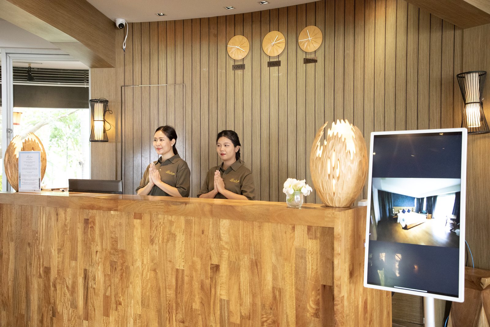 The Leela team welcoming guests at the front desk