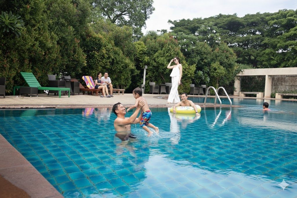 Family enjoying the outdoor pool at The Leela Resort & Spa Pattaya