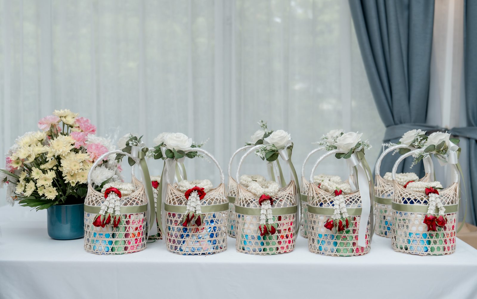 Wedding favor baskets and floral details at The Leela